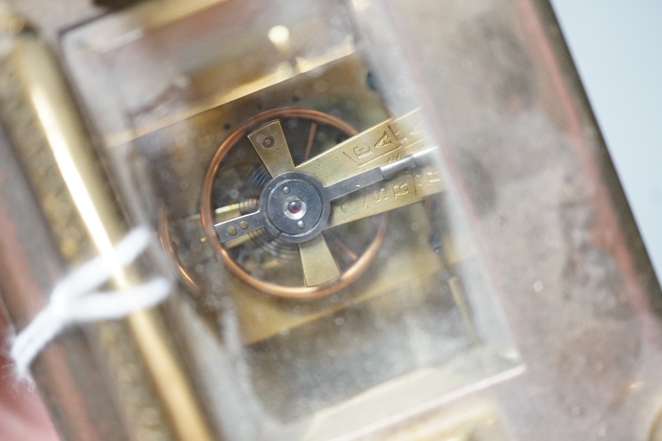 An Edwardian brass carriage timepiece, with pearl applied dial, 12cms high